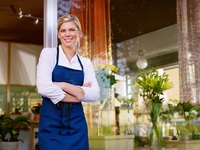 Young pretty woman working as florist in shop and smiling